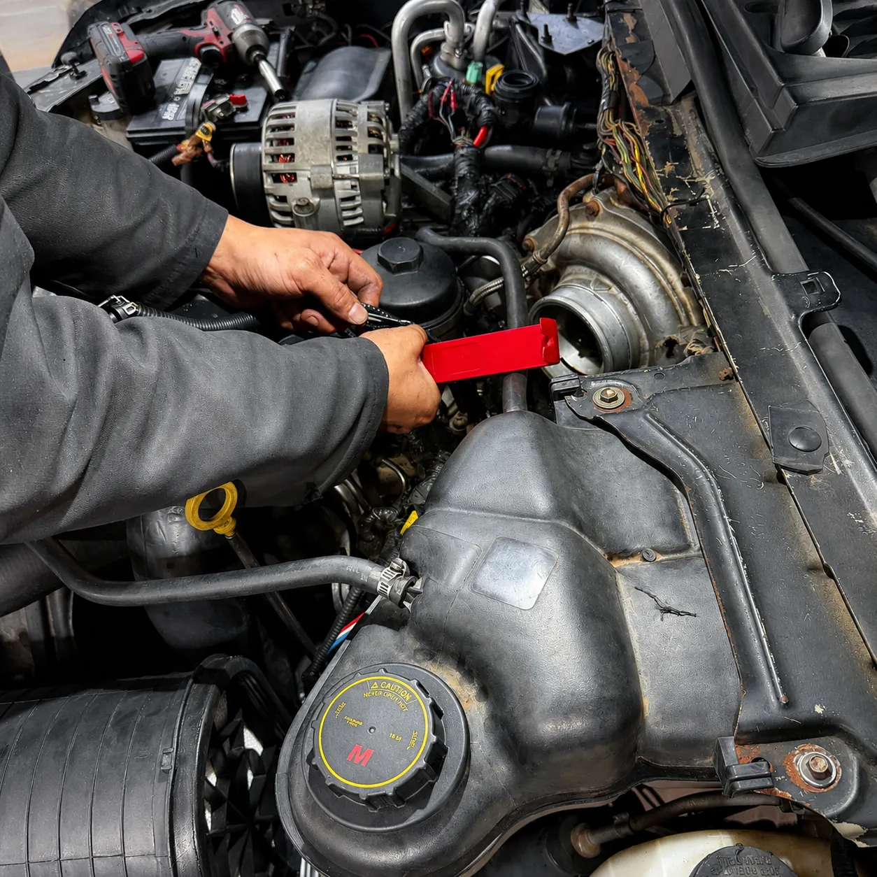 Mechanic servicing a diesel engine at Redline Shop